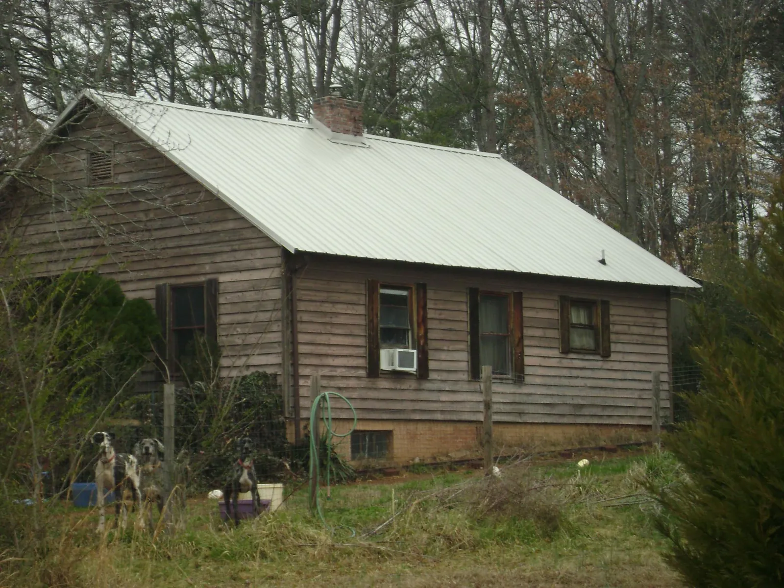 White metal roof on an old wood sided farmhouse, from a Metal Roof Installation job in Batavia